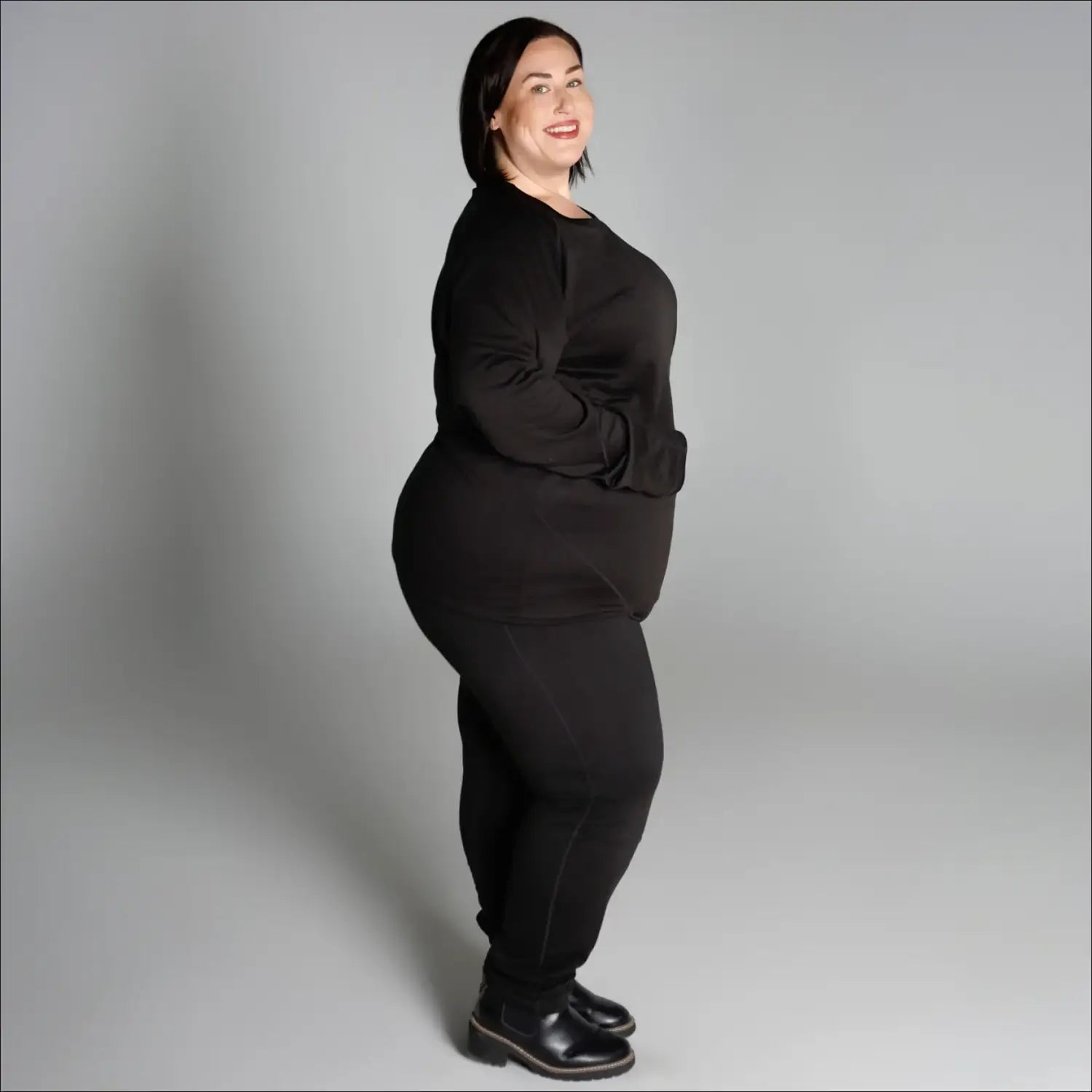 Woman in black outfit wearing Snow Country Outerwear Women’s Plus Size 1X-6X base layer