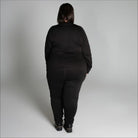 Woman in black athletic wear showcasing Snow Country Outerwear women’s plus size base layer