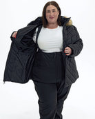 Black The Axtell plus size hooded winter parka, worn open showing the plush fleece lining | Model is 5'4" and wears a 3X