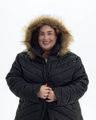 Black The Axtell plus size hooded winter parka, hood up with faux fur trim | Model is 5'4" and wears a 3X
