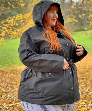 woman wearing plus size rain jacket in fall