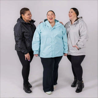 Three women wearing Plus Size Rain Jackets in a rainy outdoor setting