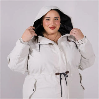 Beige plus size rain jacket on model, front image with hood up