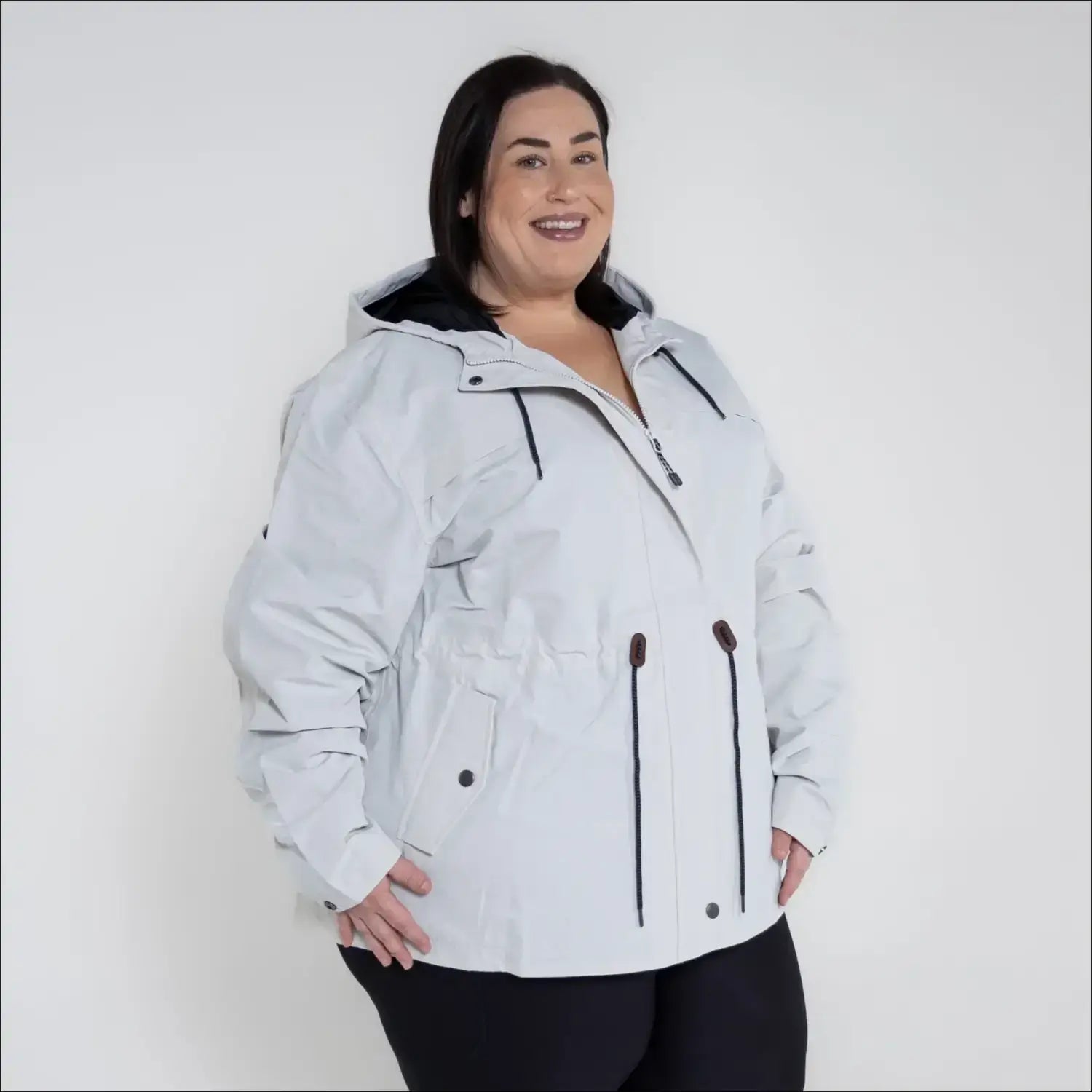 Beige plus size rain jacket on model, side image