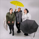 Women with umbrellas wearing Women’s Plus Size Rain Jackets