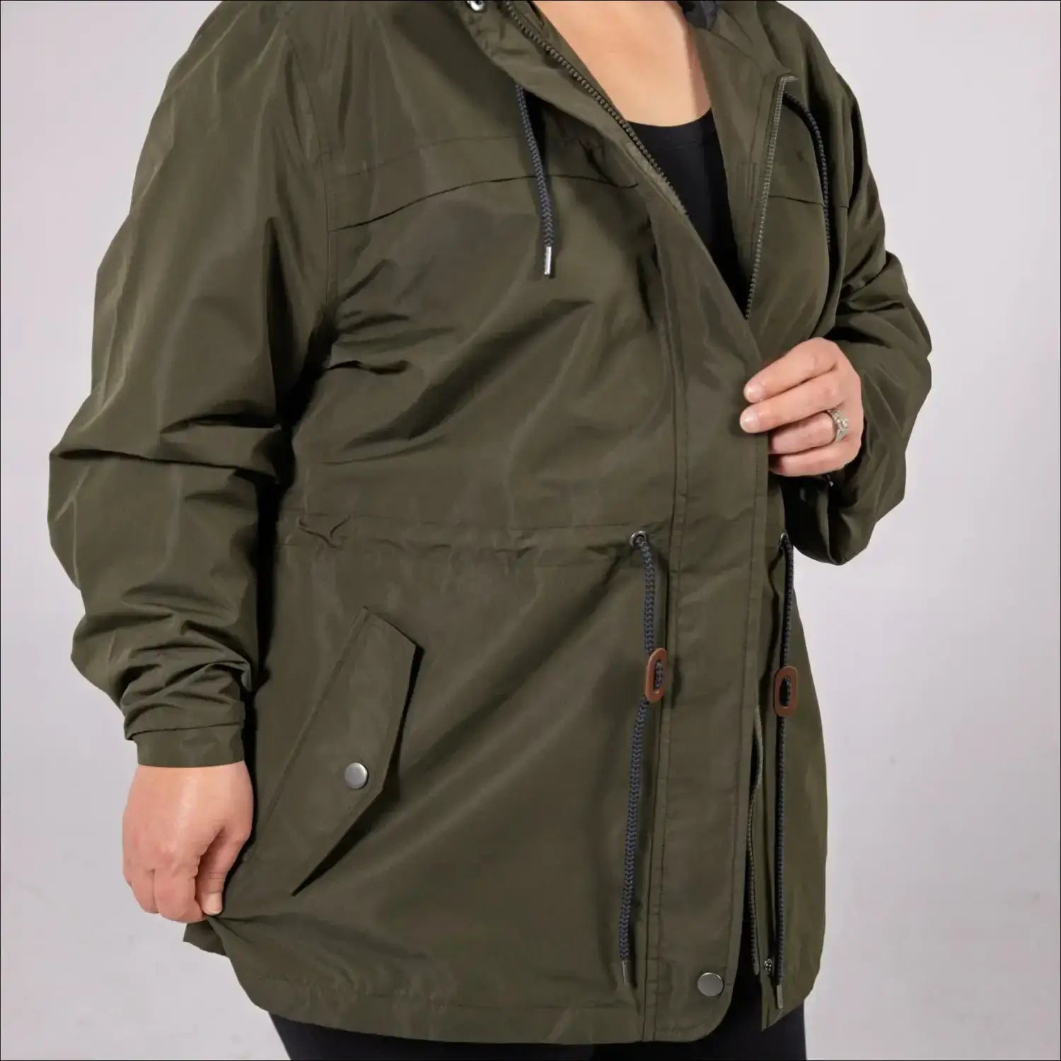 Green plus size rain jacket on model, side image
