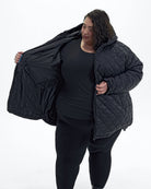 Black The Savvy II plus size quilted jacket, worn open, side | Model is 5'4" and wears a 5X