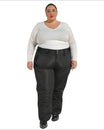 Woman wearing black Snow Country insulated plus size ski pants in a snowy mountain setting