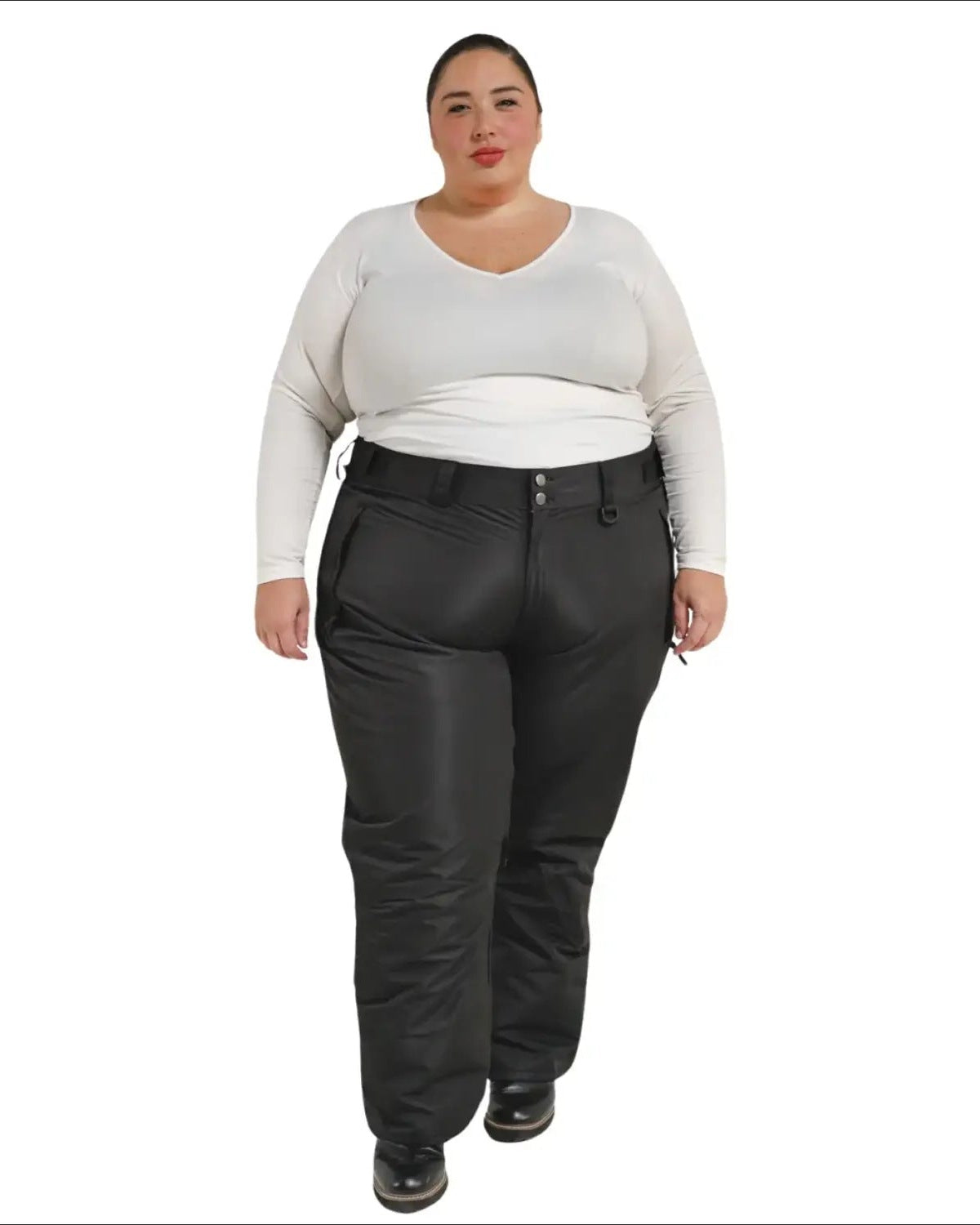 Woman wearing black Snow Country insulated plus size ski pants in a snowy mountain setting