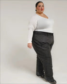Woman wearing a white top and black pants showcasing Snow Country Plus Size Insulated Ski Pants