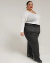 Woman wearing a white top and black pants showcasing Snow Country Plus Size Insulated Ski Pants