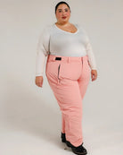 Woman wearing pink Snow Country insulated ski pants in a winter outdoor setting