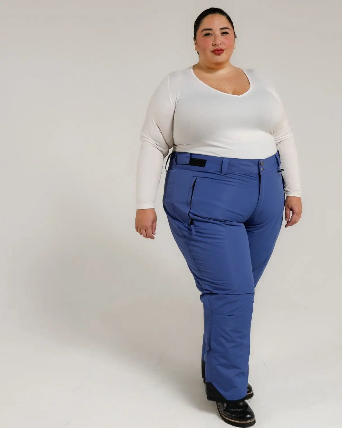 Woman wearing blue Snow Country insulated plus size ski pants for women