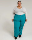 Woman wearing teal Snow Country insulated ski pants for plus size winter outdoor activity