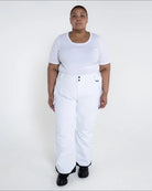 Woman wearing white insulated ski pants in Snow Country Outerwear Plus Size collection
