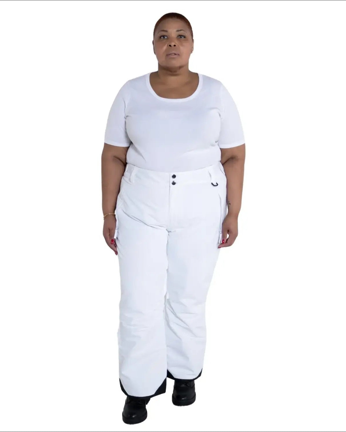 Woman wearing white ski pants and t-shirt in Snow Country Outerwear plus size insulated ski pants