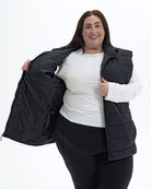 Black Tempo II women's plus size insulated vest, worn open showing the quilted lining | Model is 5'4" and wears a 3X